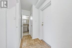 Hamilton (Durand) condo for rent - A hallway with a wooden floor and white walls leading to a bedroom.
