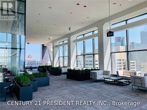 Toronto (University) condo for rent - A large open space with lots of windows and furniture.
