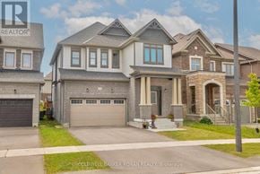 New Tecumseth apartment for rent - A row of houses with the middle one having a grey garage door.