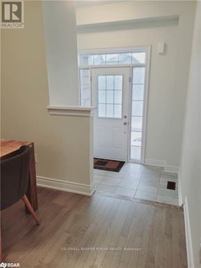 New Tecumseth apartment for rent - A white door is in a room with a wooden floor.