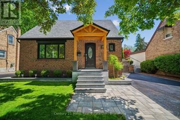 Mississauga (Mineola) apartment for rent - A house with a brick facade and a large front door is for sale.