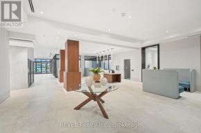 Grimsby (Grimsby Beach) condo for rent - A modern office space with a glass table and chairs in the center.