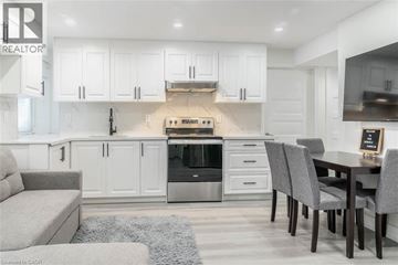 Milton apartment for rent - A modern kitchen with white cabinets and stainless steel appliances.