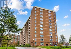 Toronto (Newtonbrook West) condo for rent - A tall brick apartment building with a clear blue sky in the background.