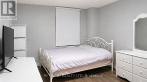 Toronto (Newtonbrook West) condo for rent - A bedroom with a white bed, dresser, and mirror.
