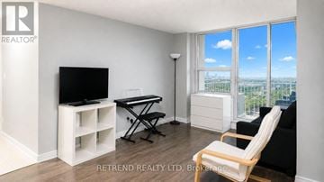 Toronto (Newtonbrook West) condo for rent - A living room with a television, a chair, and a table.