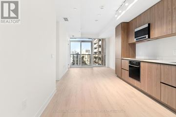 Toronto (Mount Pleasant West) condo for rent - A spacious kitchen with wooden cabinets and a microwave on top.