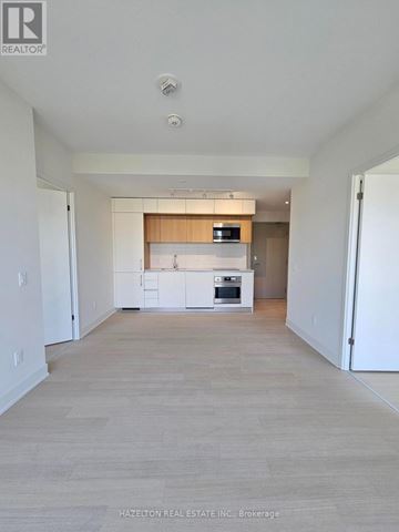Toronto (Annex) condo for rent - A spacious kitchen with white cabinets and a wooden island.