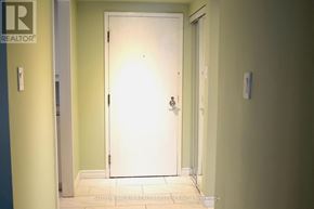 Toronto (Bay Street Corridor) condo for rent - A white door in a hallway with a brochure for Sutton Group Realty Systems Inc.