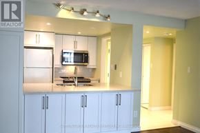 Toronto (Bay Street Corridor) condo for rent - A kitchen with white cabinets and a microwave above the stove.