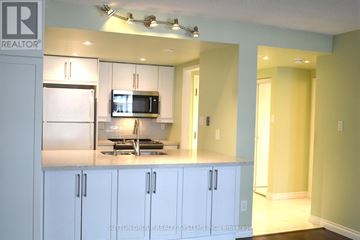 Toronto (Bay Street Corridor) condo for rent - A kitchen with white cabinets and a microwave above the stove.