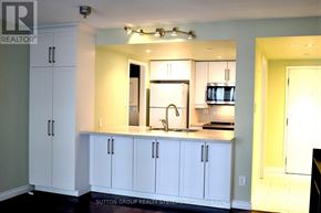Toronto (Bay Street Corridor) condo for rent - A kitchen with white cabinets and a sink.