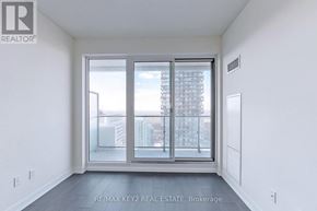 Toronto (Mount Pleasant West) condo for rent - A room with a large window and a view of a cityscape.