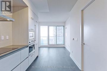 Toronto (Mount Pleasant West) condo for rent - A kitchen with white cabinets and a window.