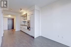 Toronto (Mount Pleasant West) condo for rent - A kitchen with white cabinets and a wooden floor.