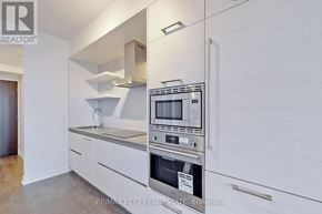 Toronto (Mount Pleasant West) condo for rent - A modern kitchen with white cabinets and stainless steel appliances.