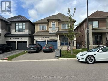 Brampton (Northwest Brampton) apartment for rent - A white Tesla car is parked in front of a house.