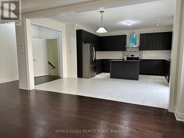 Brampton (Northwest Brampton) apartment for rent - A spacious kitchen with black cabinets and a white island.