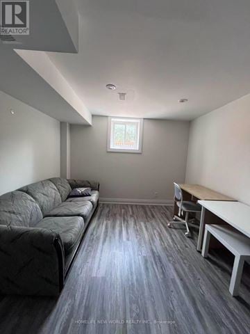Richmond Hill (Devonsleigh) apartment for rent - A living room with a grey couch and a wooden floor.