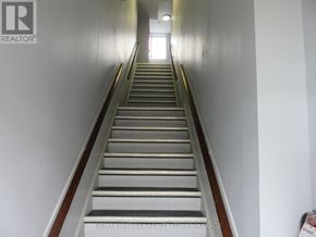 Fort Erie (Central) multi-family for rent - A staircase with a light at the top.