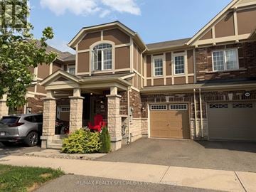 Milton (Fo Ford) townhouse for rent - A large house with a garage is shown in the image.