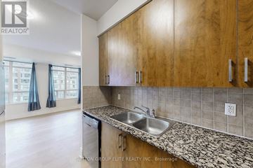 Mississauga (City Centre) condo for rent - A kitchen with wooden cabinets and a granite countertop.