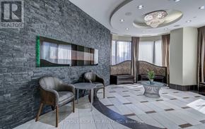 Mississauga (City Centre) condo for rent - A modern living room with a stone wall and a large window.