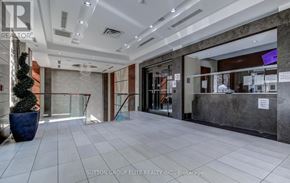 Mississauga (City Centre) condo for rent - The image shows the front desk of a real estate office with a receptionist behind the counter.