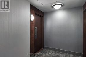 Mississauga (City Centre) condo for rent - A hallway with a brokerage logo on the wall.