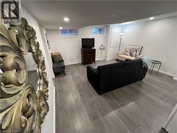 Cambridge apartment for rent - A living room with a black couch and a golden decorative piece on the wall.