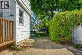 Milton apartment for rent - A white house with a wooden fence and a car parked in the driveway.