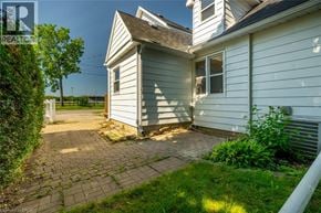 Milton apartment for rent - A backyard with a brick patio and a white house.