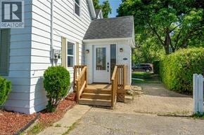 Milton apartment for rent - A white house with a REALTOR® sign on the front.
