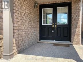 Milton (Be Beaty) apartment for rent - A black double door with a glass window is flanked by two pillars.