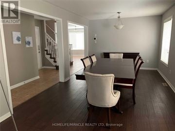 Milton (Be Beaty) apartment for rent - A living room with a white chair and a wooden table.