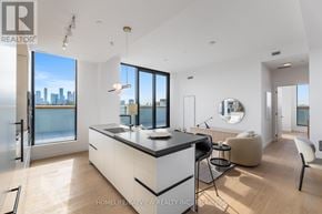 Toronto (Mount Pleasant East) condo for rent - A modern kitchen with a large island and a view of the city.