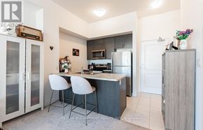 Hamilton (Waterdown) condo for rent - A kitchen with a white countertop and a white fridge.