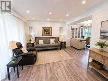 Oakville (Fd Ford) apartment for rent - A living room with a grey sofa and a black leather chair.