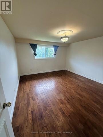 Toronto (Tam O'shanter-Sullivan) apartment for rent - A room with wooden flooring and a window with a view of trees.