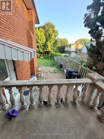 Toronto (Tam O'shanter-Sullivan) apartment for rent - A balcony with a railing and a purple object on the ground.
