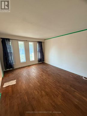 Toronto (Tam O'shanter-Sullivan) apartment for rent - A room with wooden flooring and a window with curtains.