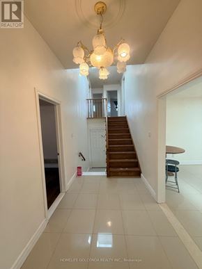 Toronto (Tam O'shanter-Sullivan) apartment for rent - A hallway with a staircase and a chandelier.