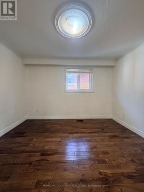 Toronto (Tam O'shanter-Sullivan) apartment for rent - A room with wooden flooring and a window with blinds.