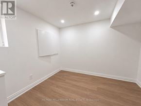 Vaughan (Kleinburg) apartment for rent - A room with white walls and wooden flooring.
