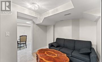 Brampton (Madoc) apartment for rent - A living room with a grey couch and a wooden coffee table.