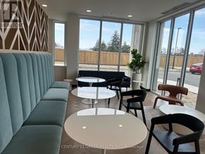 Kitchener condo for rent - A waiting area with a green sofa and chairs.