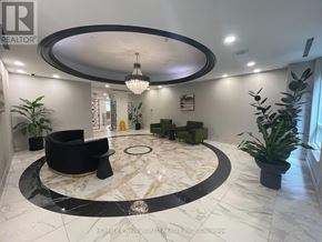 Toronto (Bendale) condo for rent - A well-lit, spacious living room with a black circular rug and a chandelier.