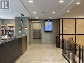 Toronto (Bendale) condo for rent - A reception area with a counter and a screen on the wall.