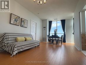 Toronto (Bendale) condo for rent - A living room with a striped couch and a dining table.