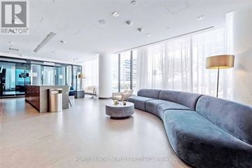 Vaughan (Vaughan Corporate Centre) condo for rent - A modern living room with a curved sofa and a coffee table.